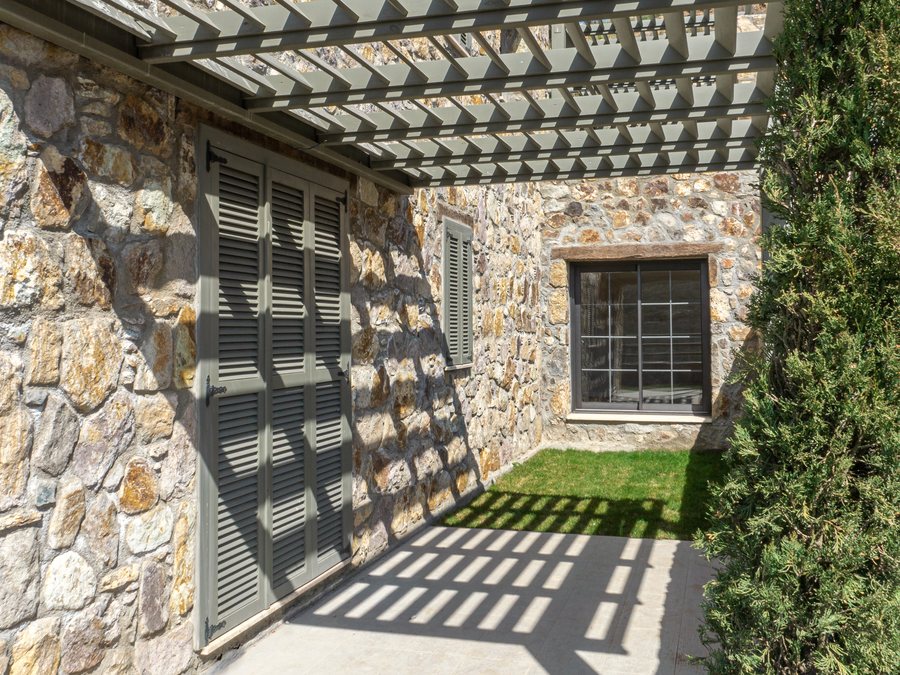 Pergola shadows on a stone wall